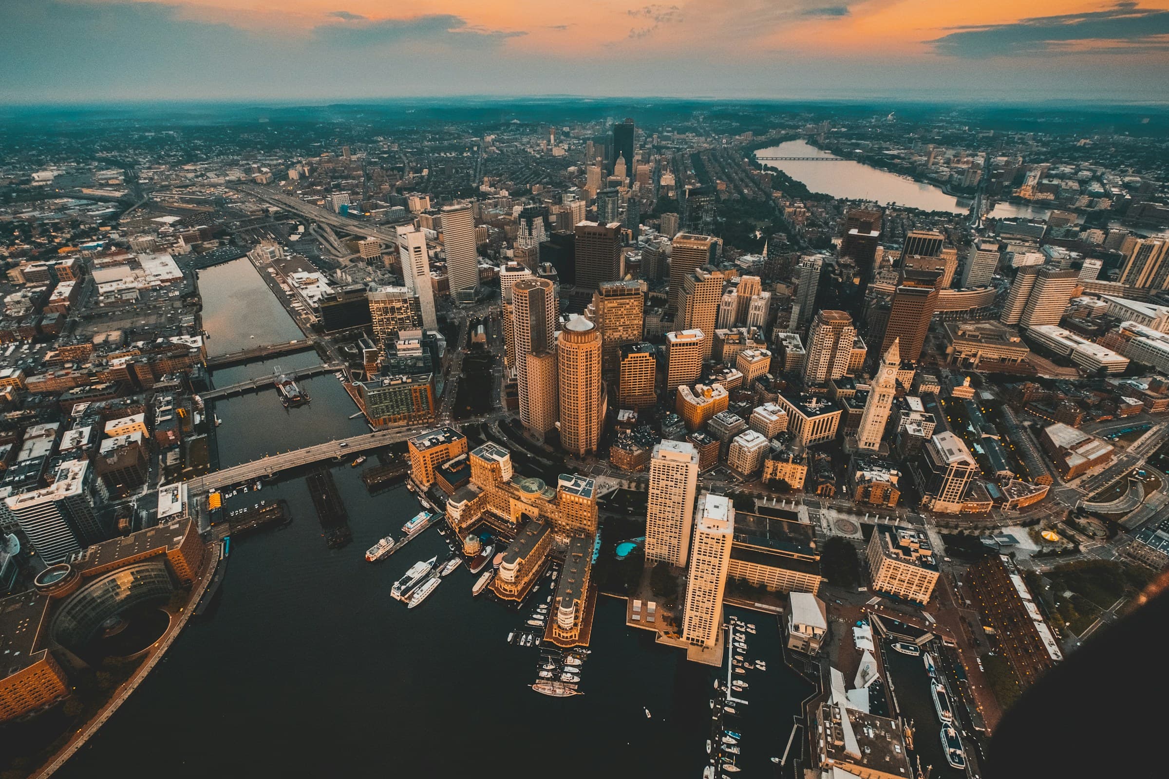 Boston's Financial District and harbor from the air at dusk