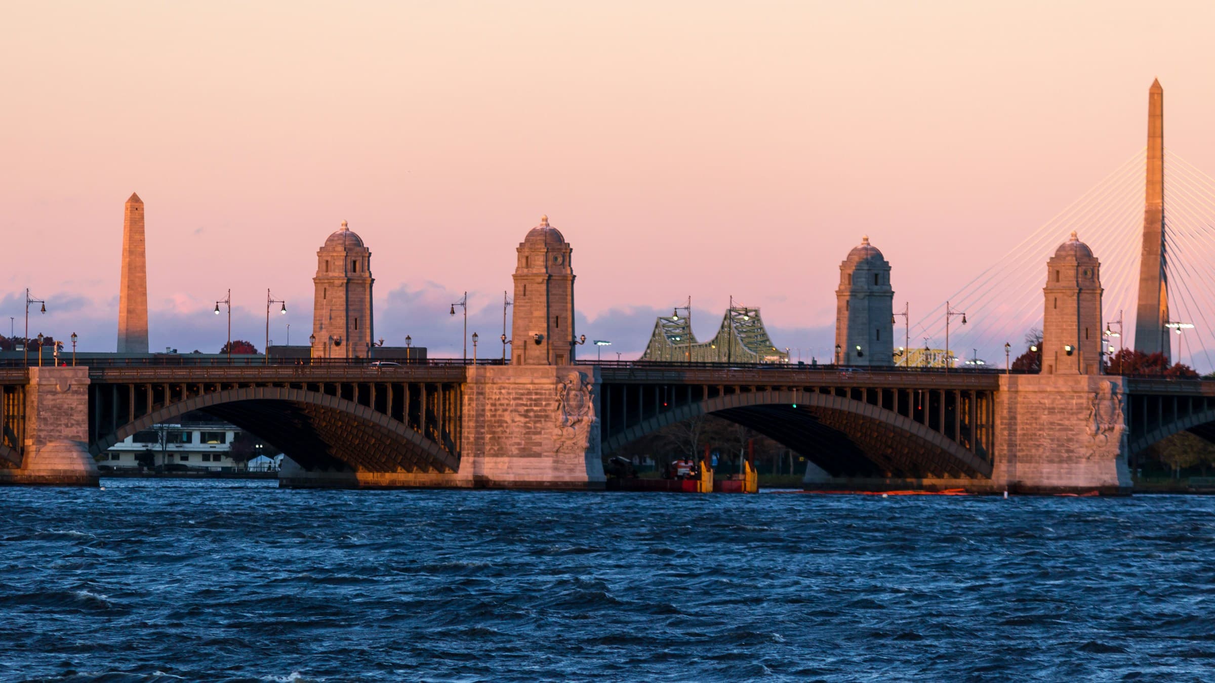 The Longfellow Bridge at sunset, its stone towers between Cambridge and Boston